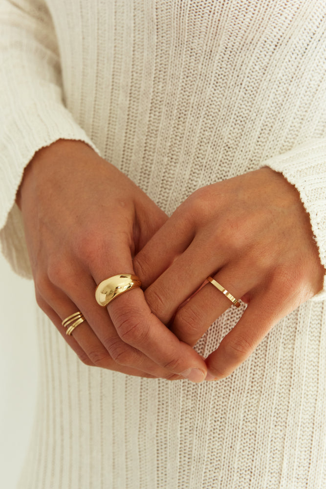 Stacked gold rings on model