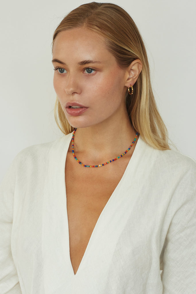 Full view of model wearing 14K Diamond Multi-Bead Necklace paired with simple gold hoops  bagatiba