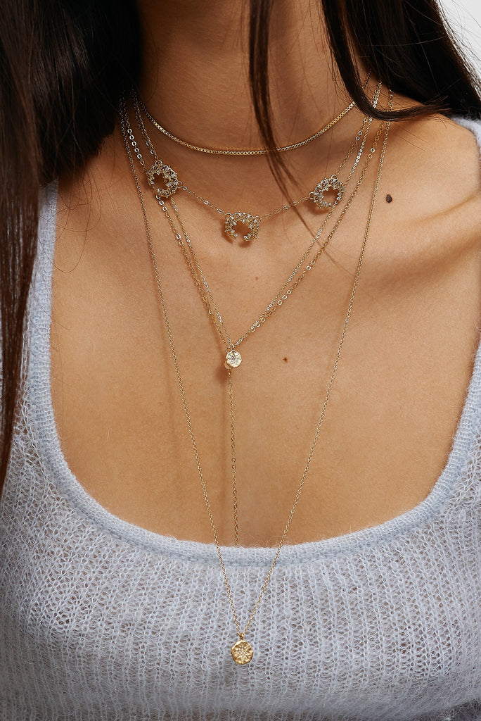 Close up on model of 14K Emma Drop Necklace layered with other Necklaces Bagatiba
