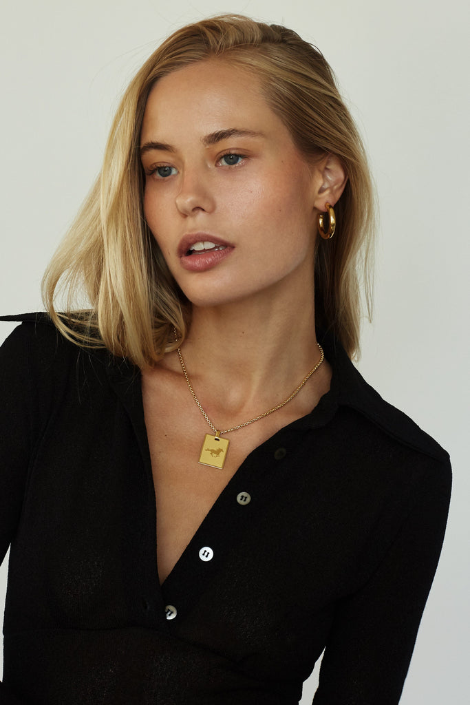 Full view on model of 16" Snake Chain Necklace with Lucky Charm added & Gold Hollow Hoops  bagatiba
