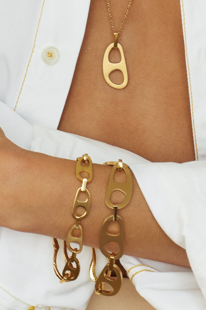 Zoomed view on model of Adjustable Gold Tab Necklace and two tab bracelet styles  bagatiba