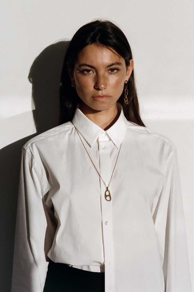 Model wearing Adjustable Gold Tab Necklace and Dangle Tab Earrings  bagatiba