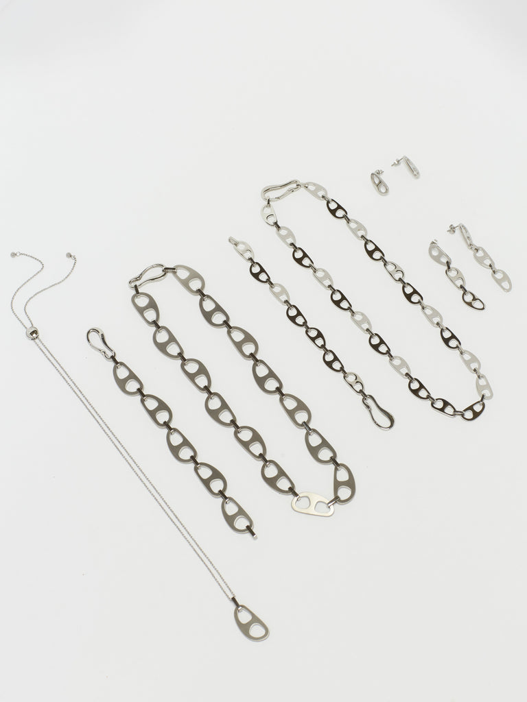 Full view flat lay of Adjustable Silver Tab Necklace with full collection  bagatiba