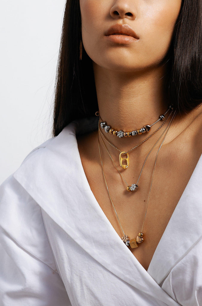 Model wearing assorted necklaces with Gold Bead Set Bagatiba