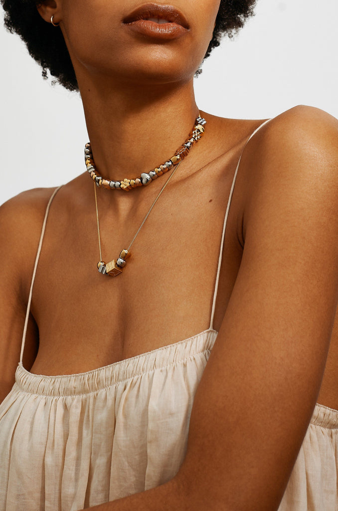Full view of model wearing two necklaces with the Gold Bead Set Bagatiba