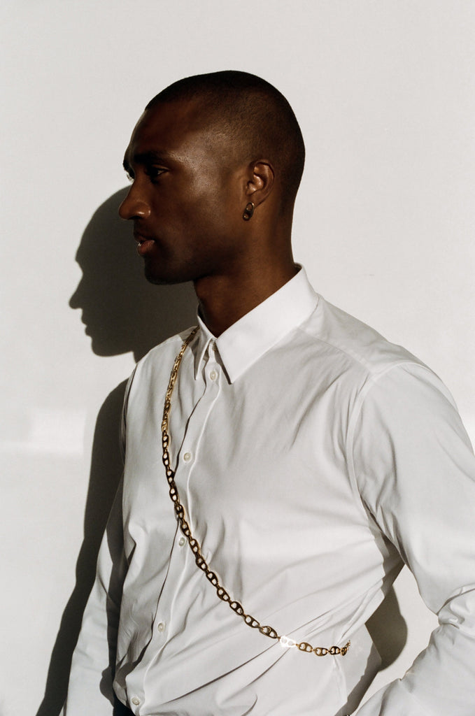 Profile view of model wearing the Gold Tab Crossbody Belt bagatiba