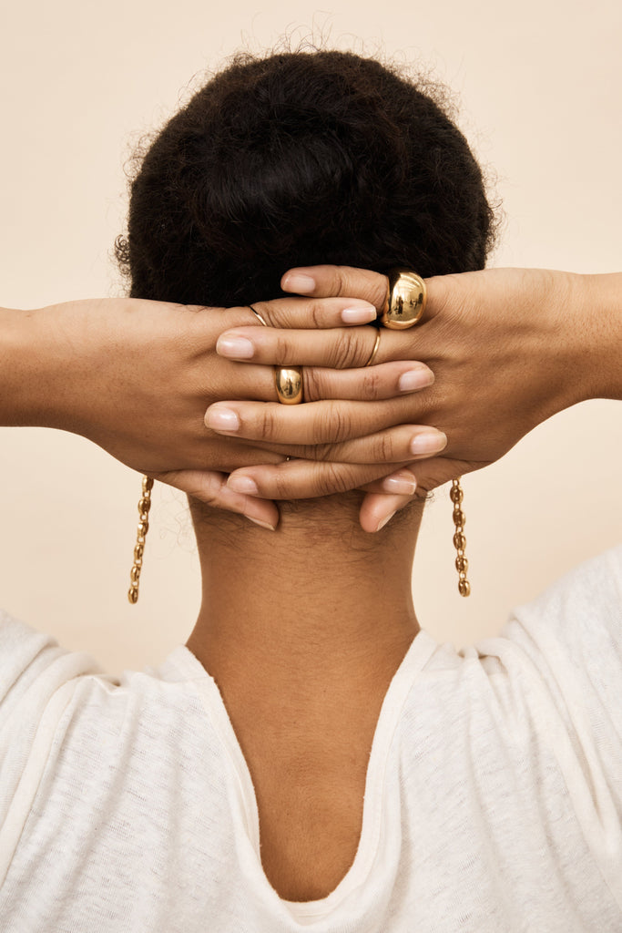 Detail view on model's hands of Small & Large  Gold Orb Ring Ring bagatiba
