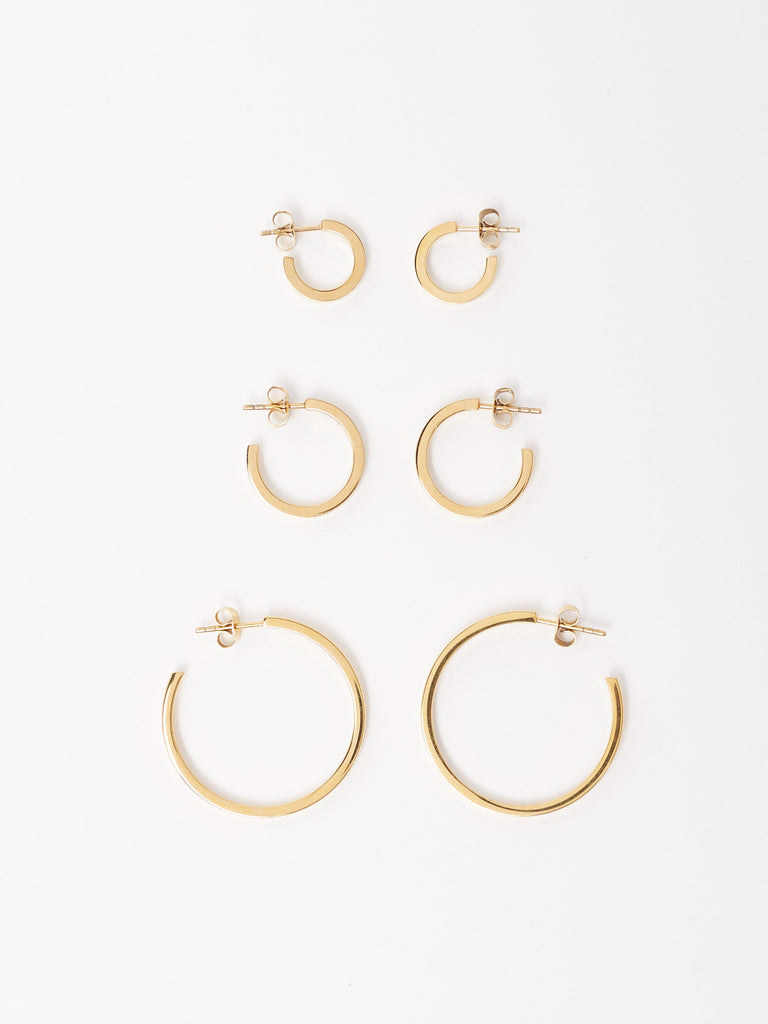 Full view flat lay of Mini Simple, Small Simple and Simple Gold Hoops Earrings Bagatiba