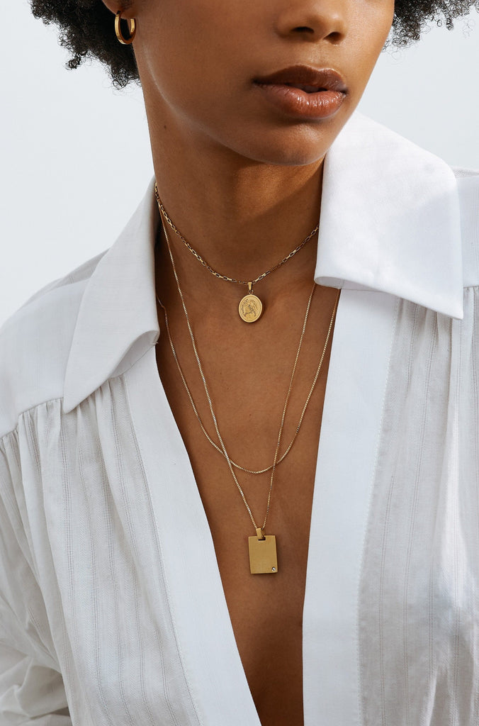 Full view of model wearing the Small Simple Gold Hoops and a few Necklace styles by  Bagatiba