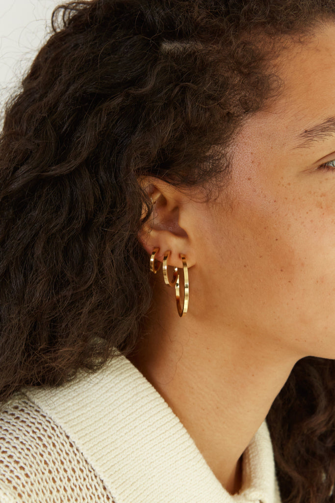 Close view on ear of Small Simple Gold Hoops Earrings Bagatiba