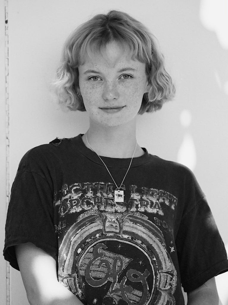 Black and white portrait of a taurus woman wearing the Taurus Charm charm Bagatiba