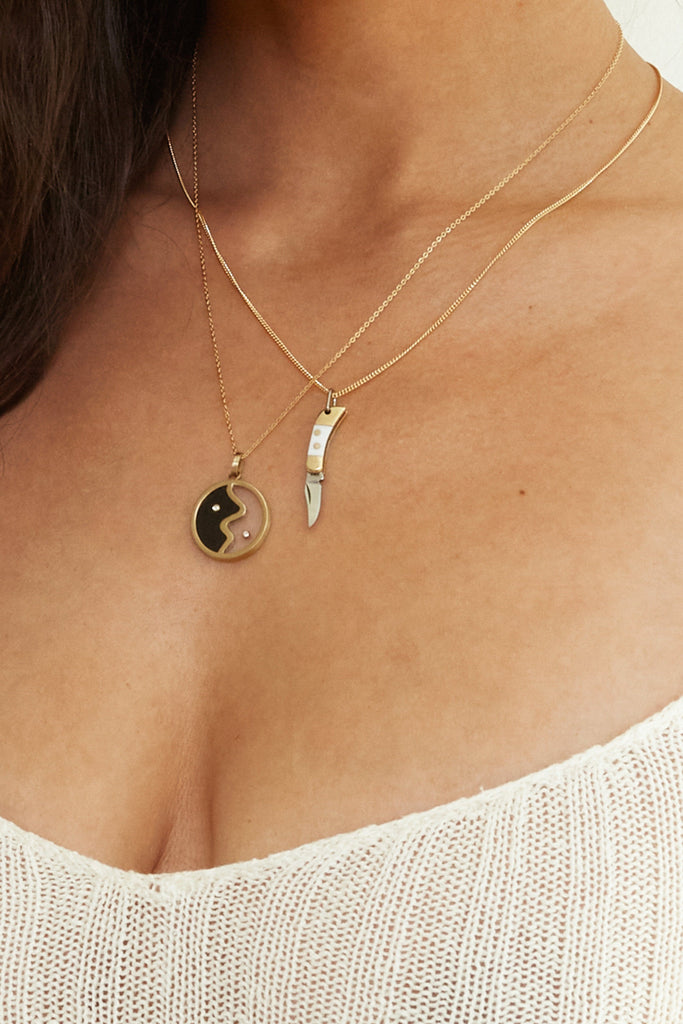Cropped view on neck of the Yin Yang Glass Necklace Necklace bagatiba