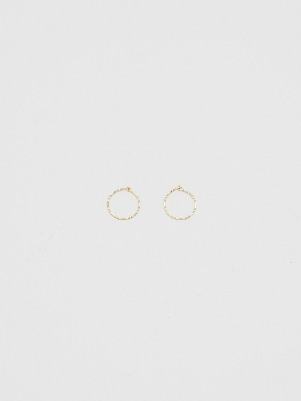 Full view flat lay of 14K 301 Mini Hoops Earrings Bagatiba 