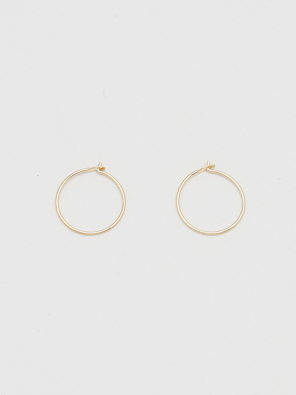 Close up flat lay of 14K 302 Mini Hoops Earrings Bagatiba 