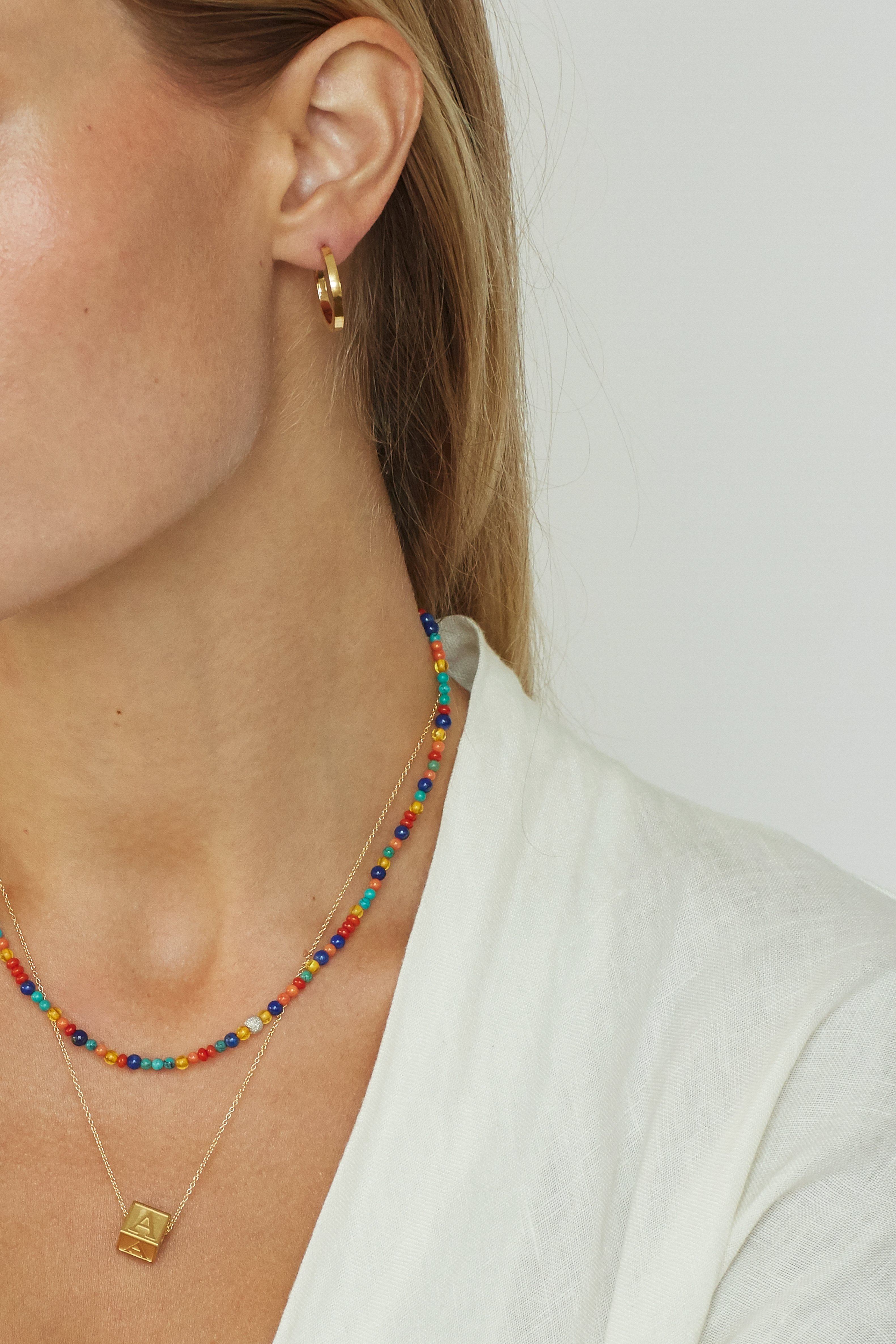 Model cropped view of 14K Diamond Multi-Bead Necklace, letter block Necklace & small simple gold hoops  bagatiba 