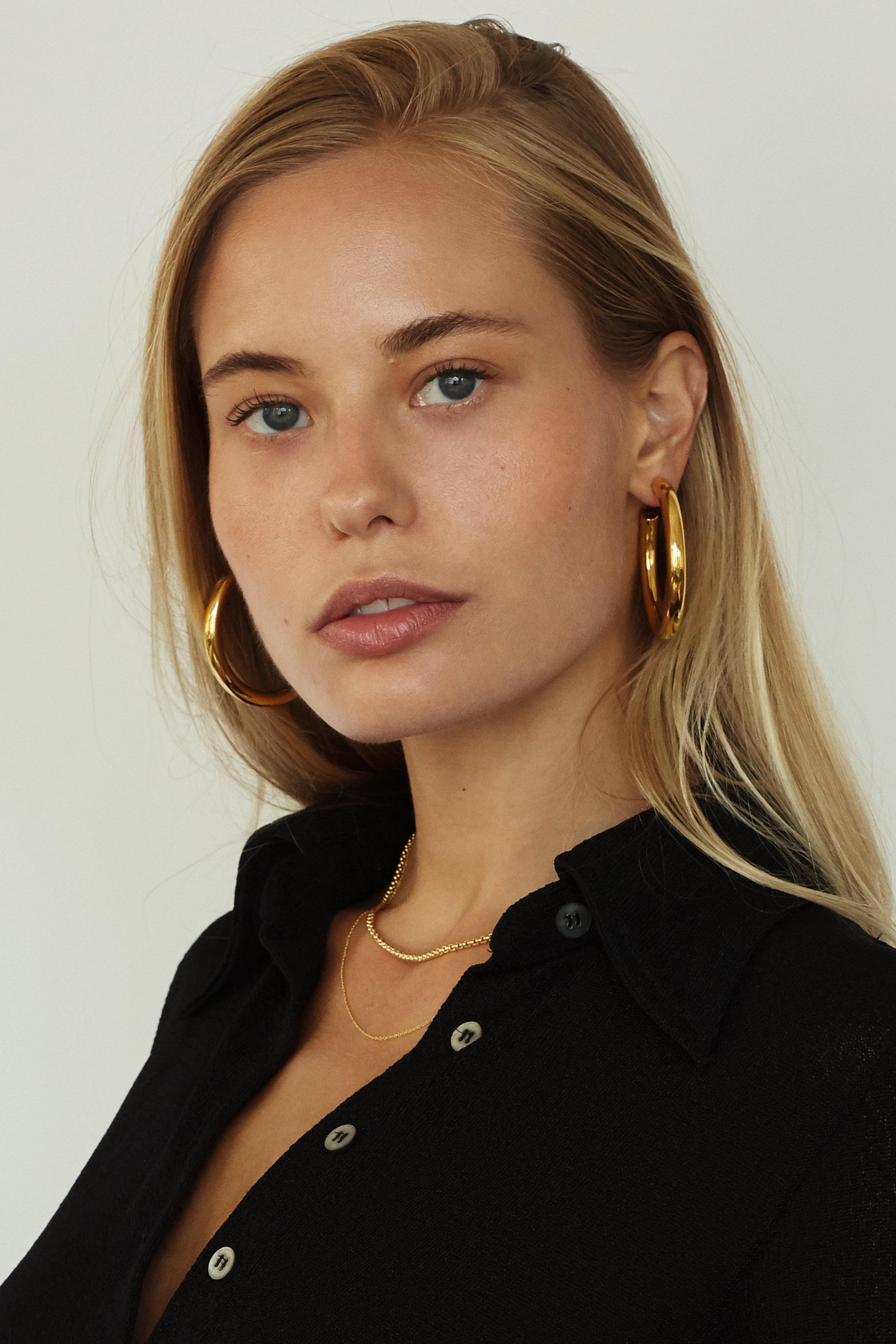 Model wearing 16" + 2" Simple Necklace paired with snake Necklace and Gold hollow hoops  bagatiba 