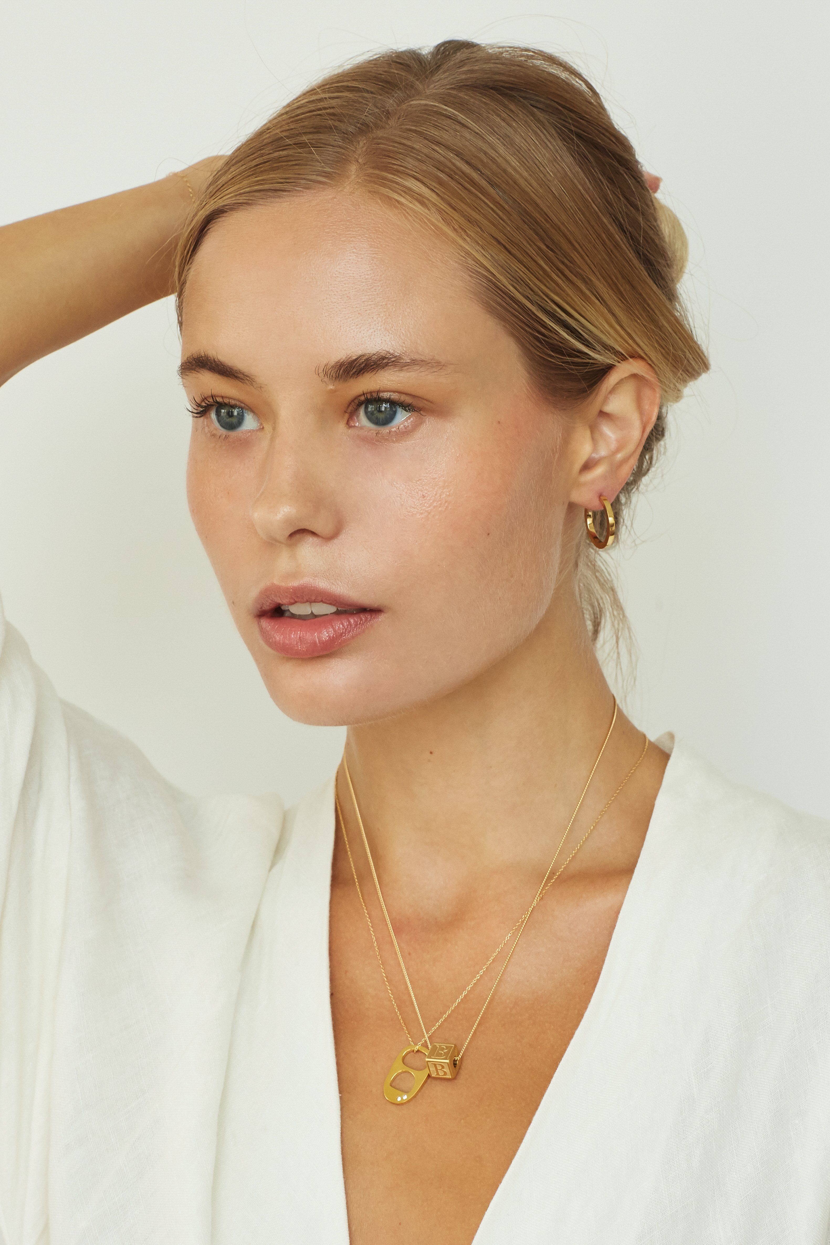 Full view of model wearing Diamond Soda Tab Charm Necklace, Letter Block Necklace & Small Simple Hoops  Bagatiba 