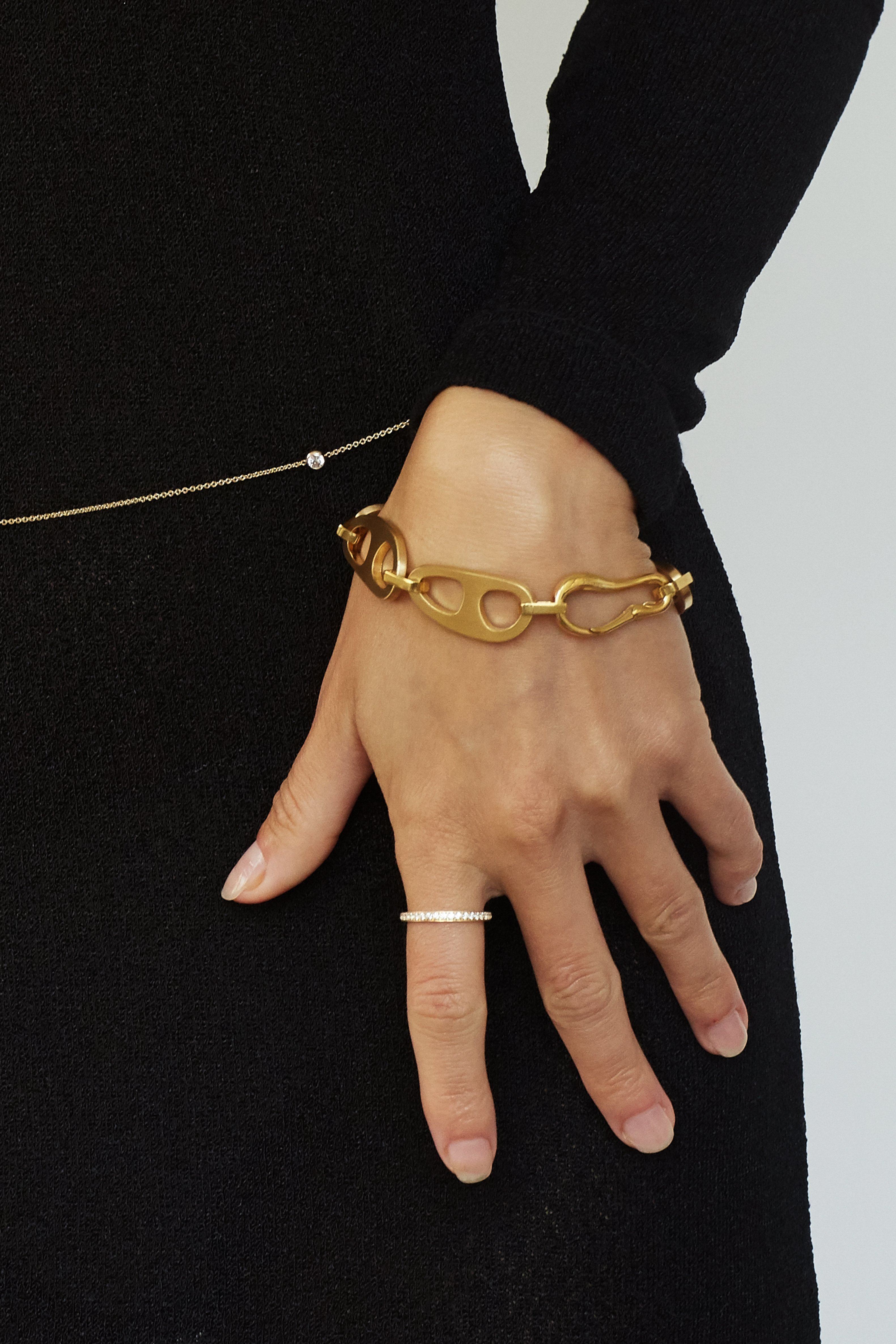 Cropped view on Model of Gold Brushed Tab Bracelet Bracelet bagatiba 