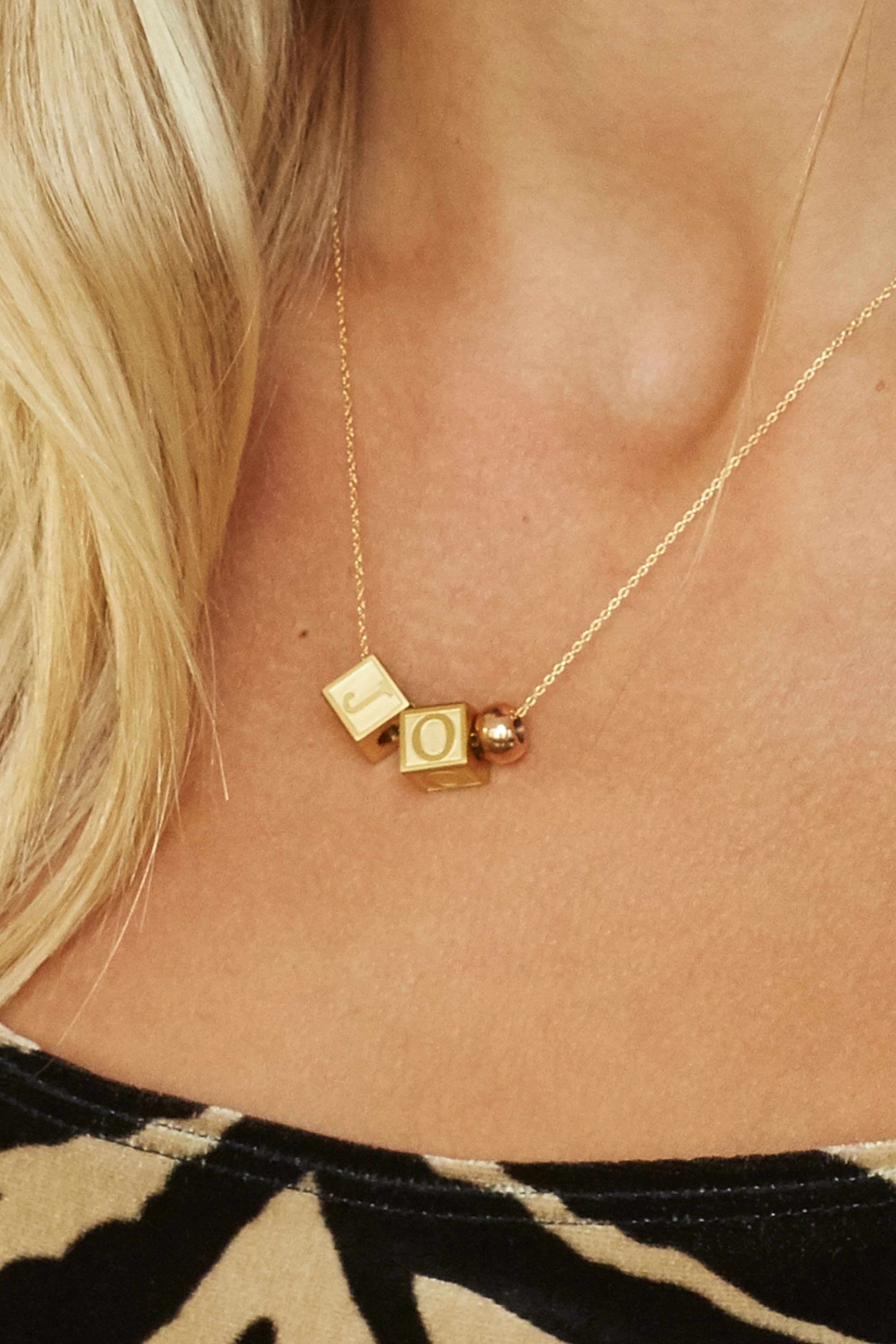 Close up of model wearing "J" "O" Letter Block letters & 1 rose gold bead  Bagatiba 