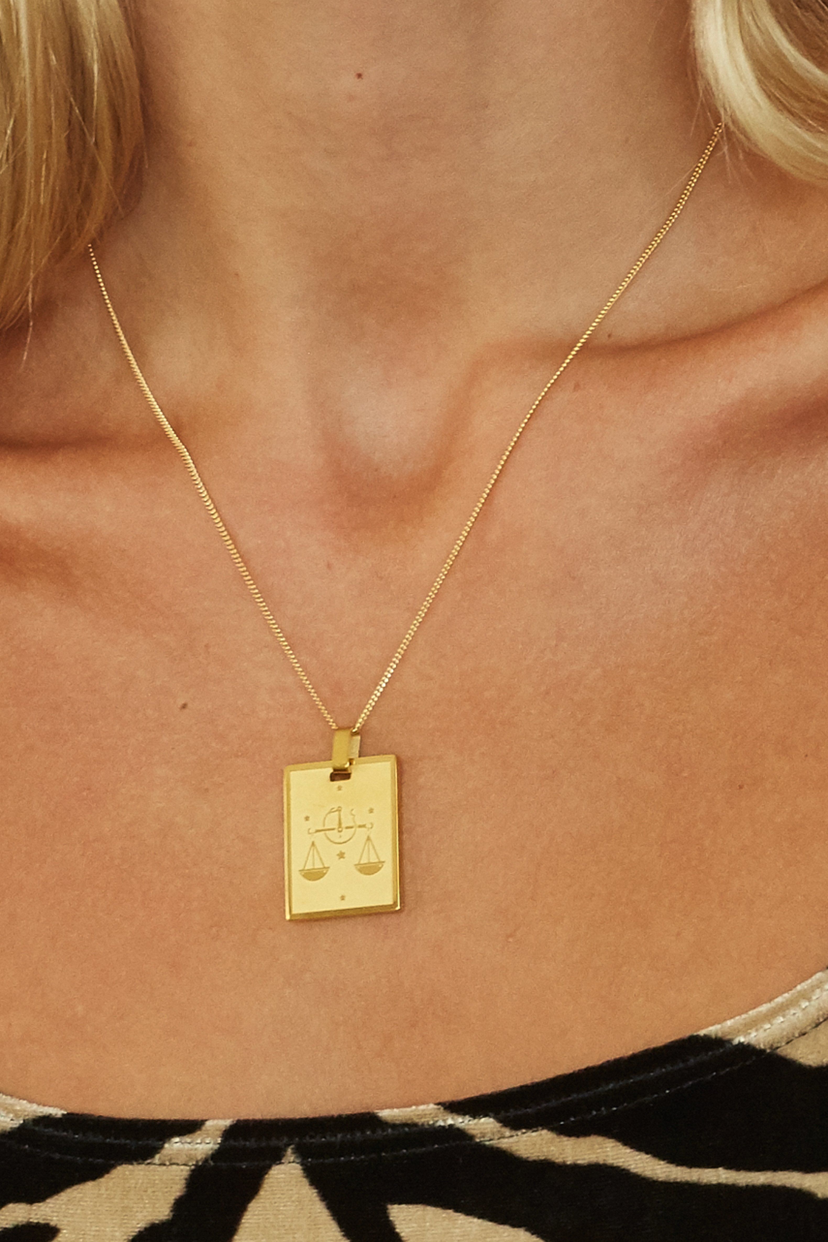 Cropped view on model of Libra Charm charm Bagatiba 
