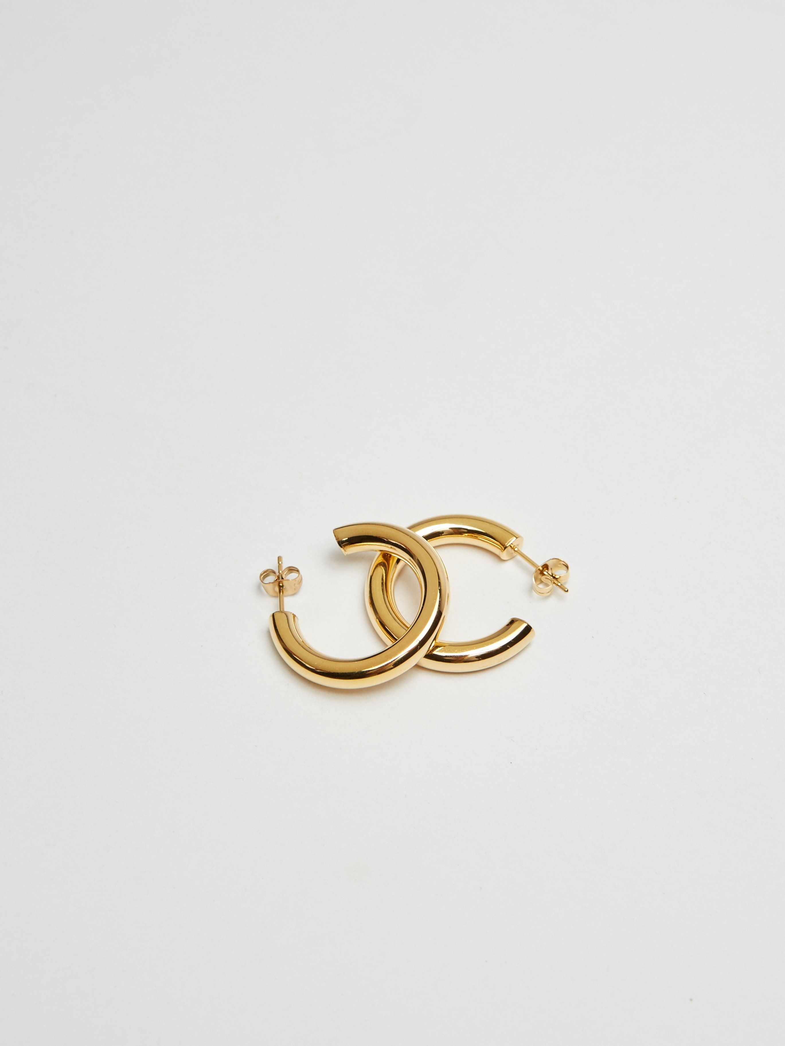 Detail flat lay of Mini Gold Hollow Hoops Earrings Bagatiba 
