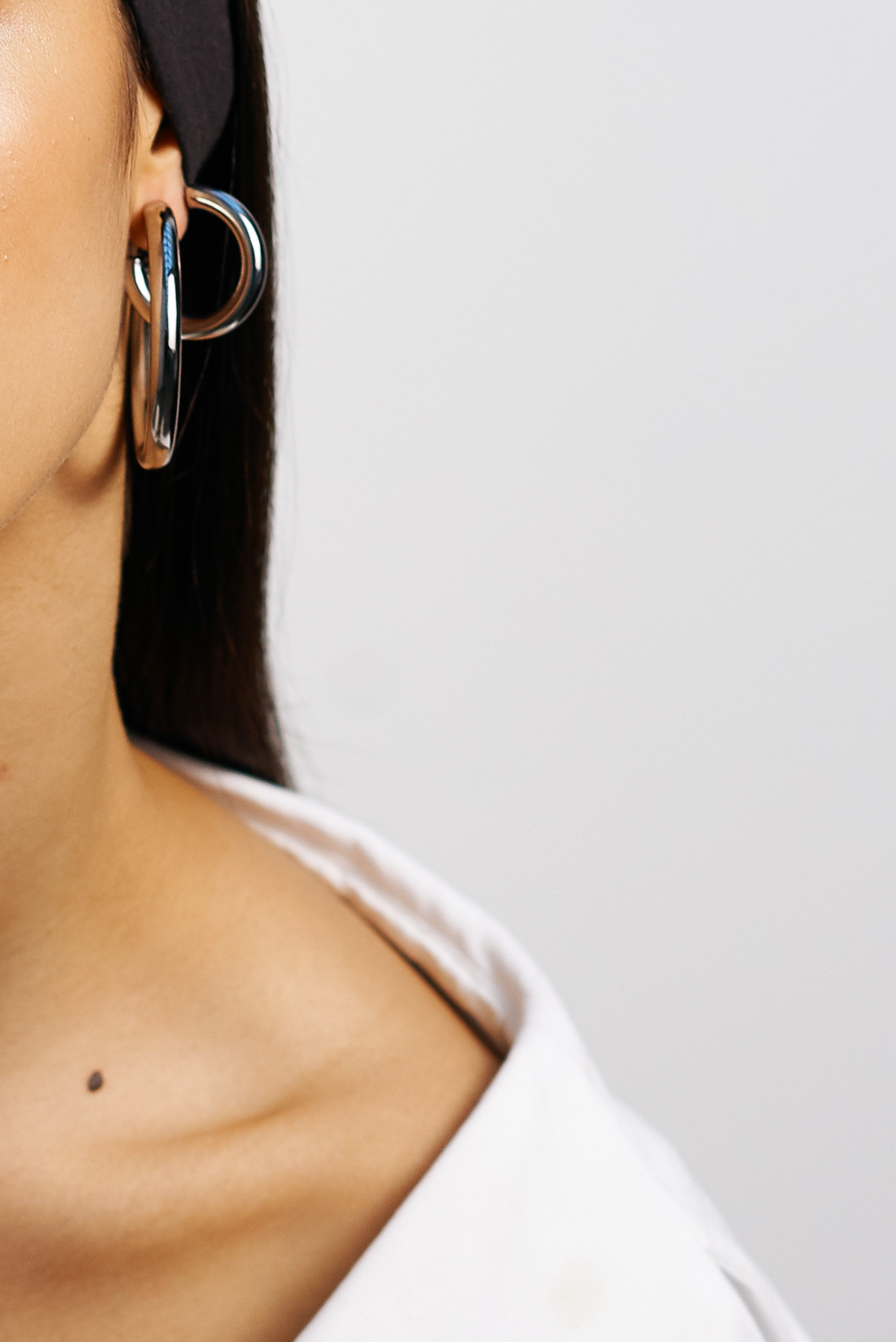 crop detail view on model of Mini Silver Hollow Hoops & Silver Hollow Hoops  Earrings Bagatiba 