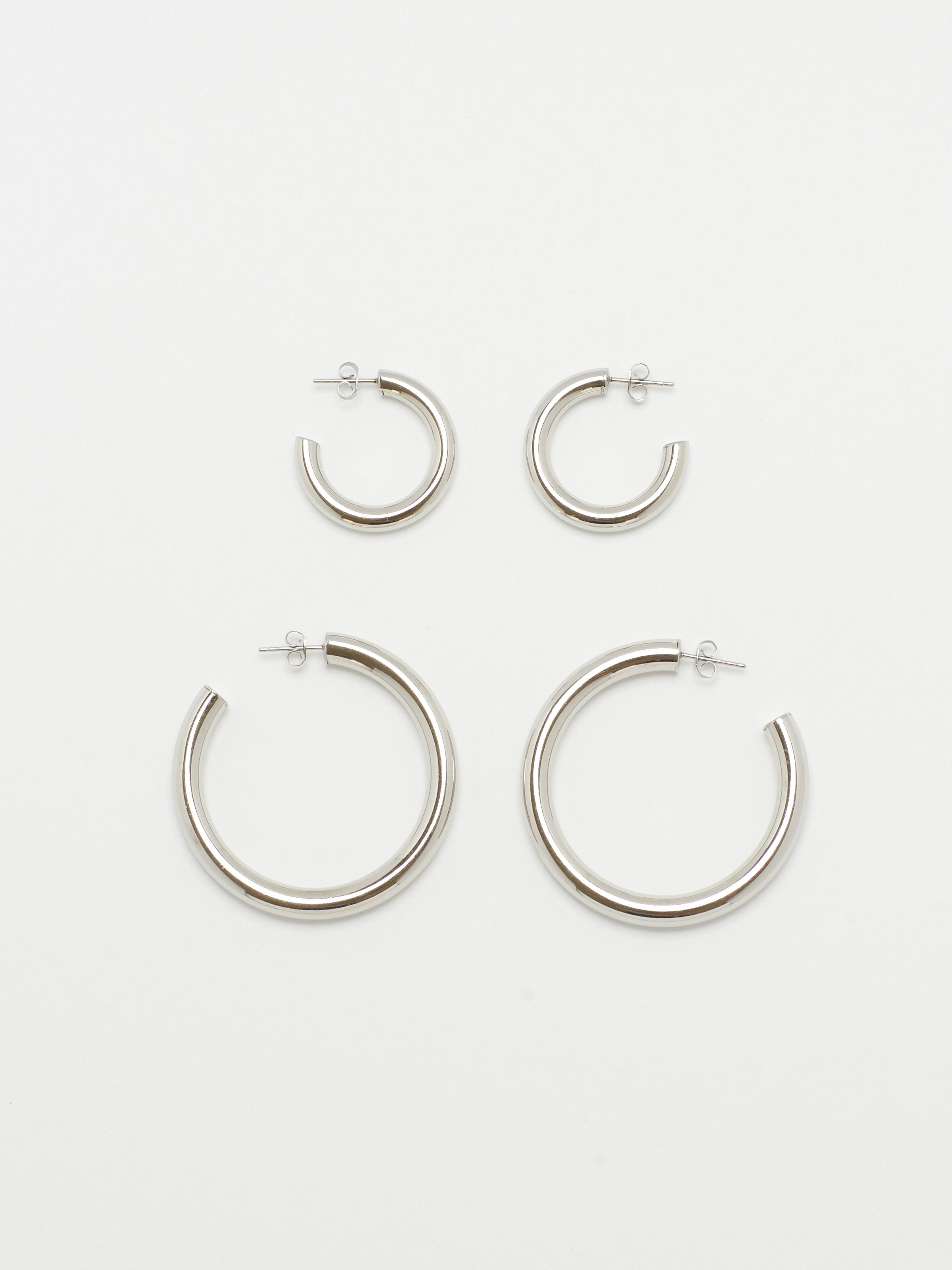Flat lay of Mini Silver Hollow Hoops & Silver Hollow Hoops  Earrings Bagatiba 