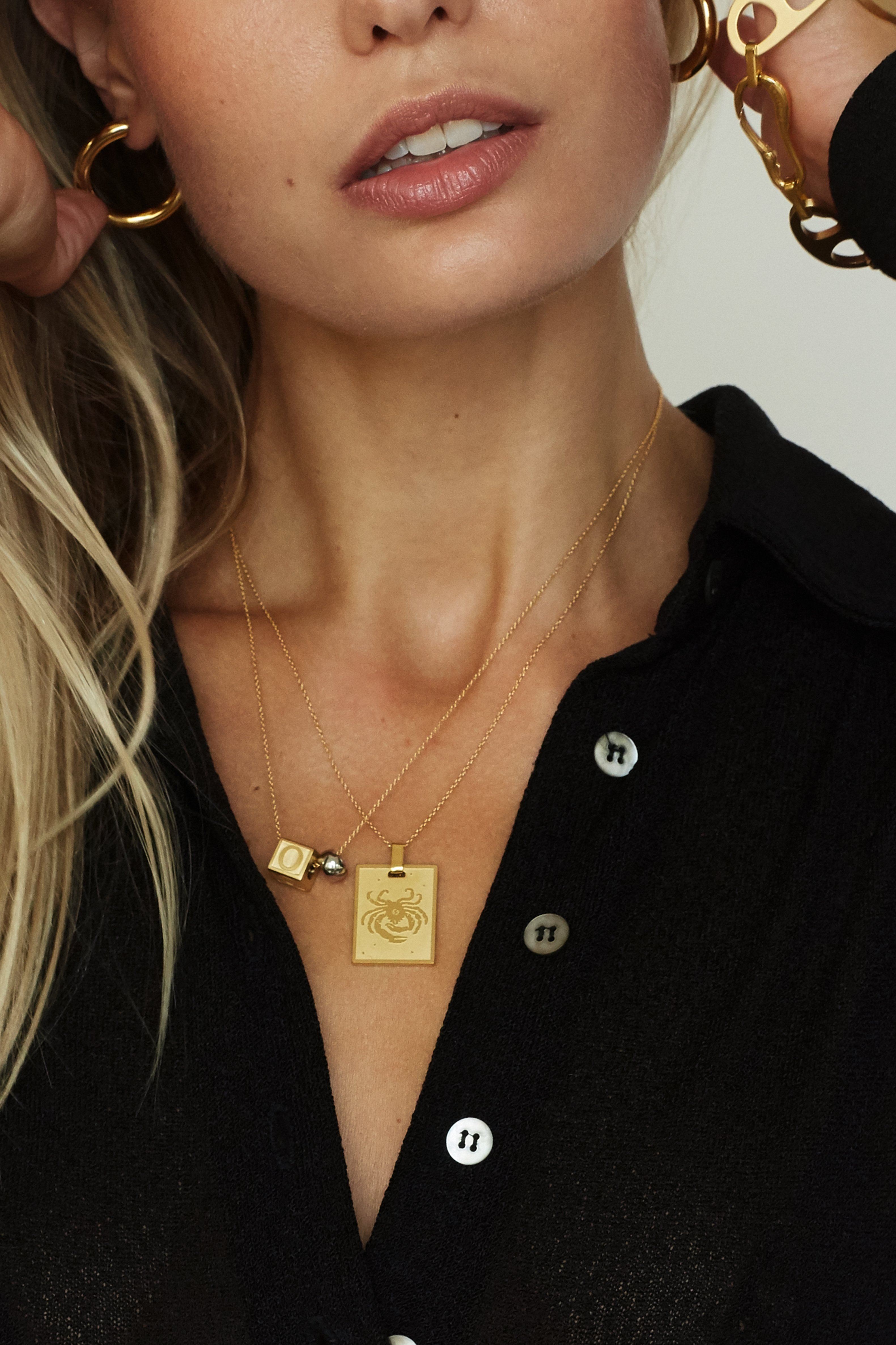 Model wearing "O" Letter Block letters layered with the zodiac charm   Bagatiba 
