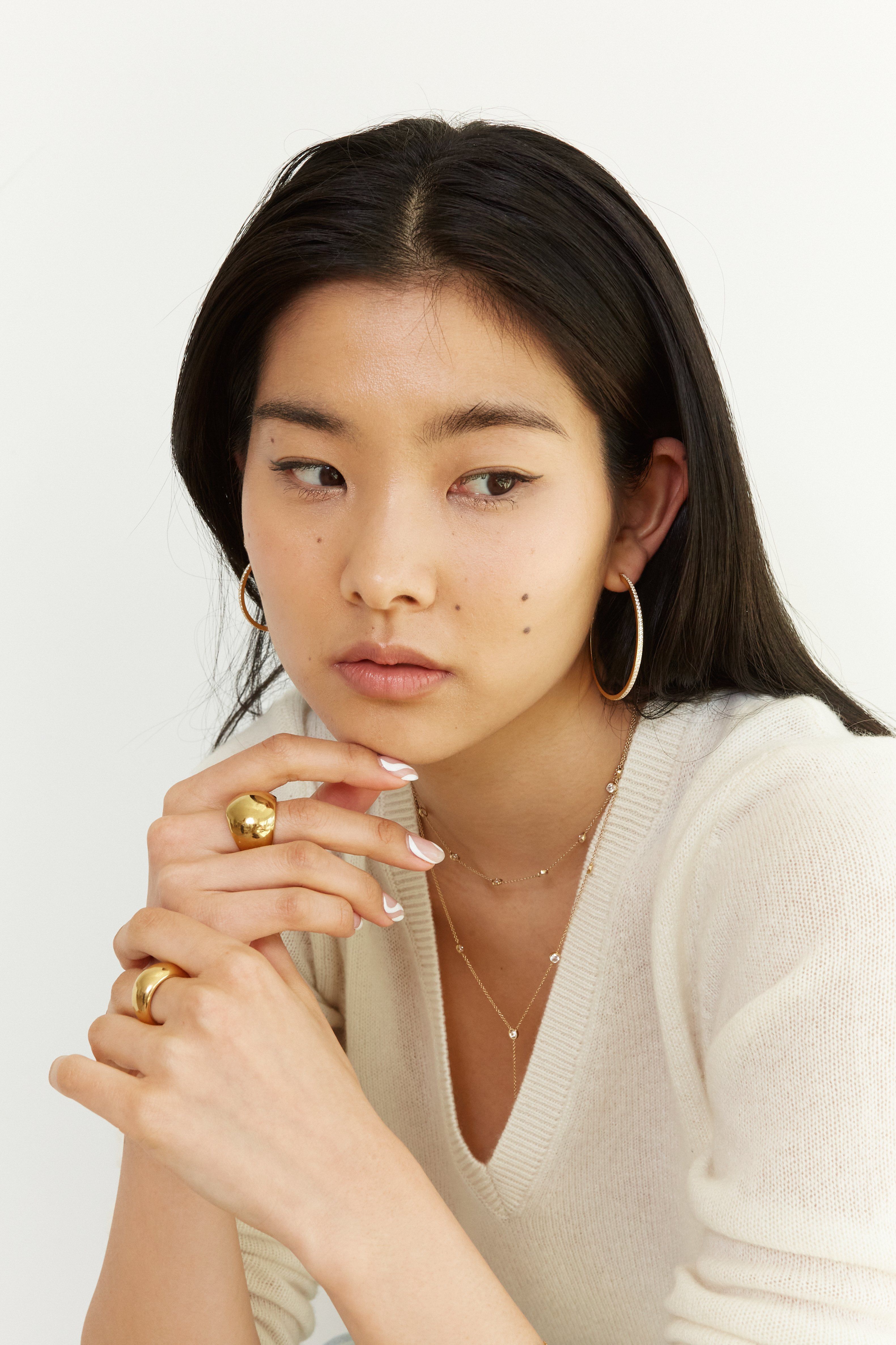 Model wearing multiple styles by Bagatiba including the Princess Choker 