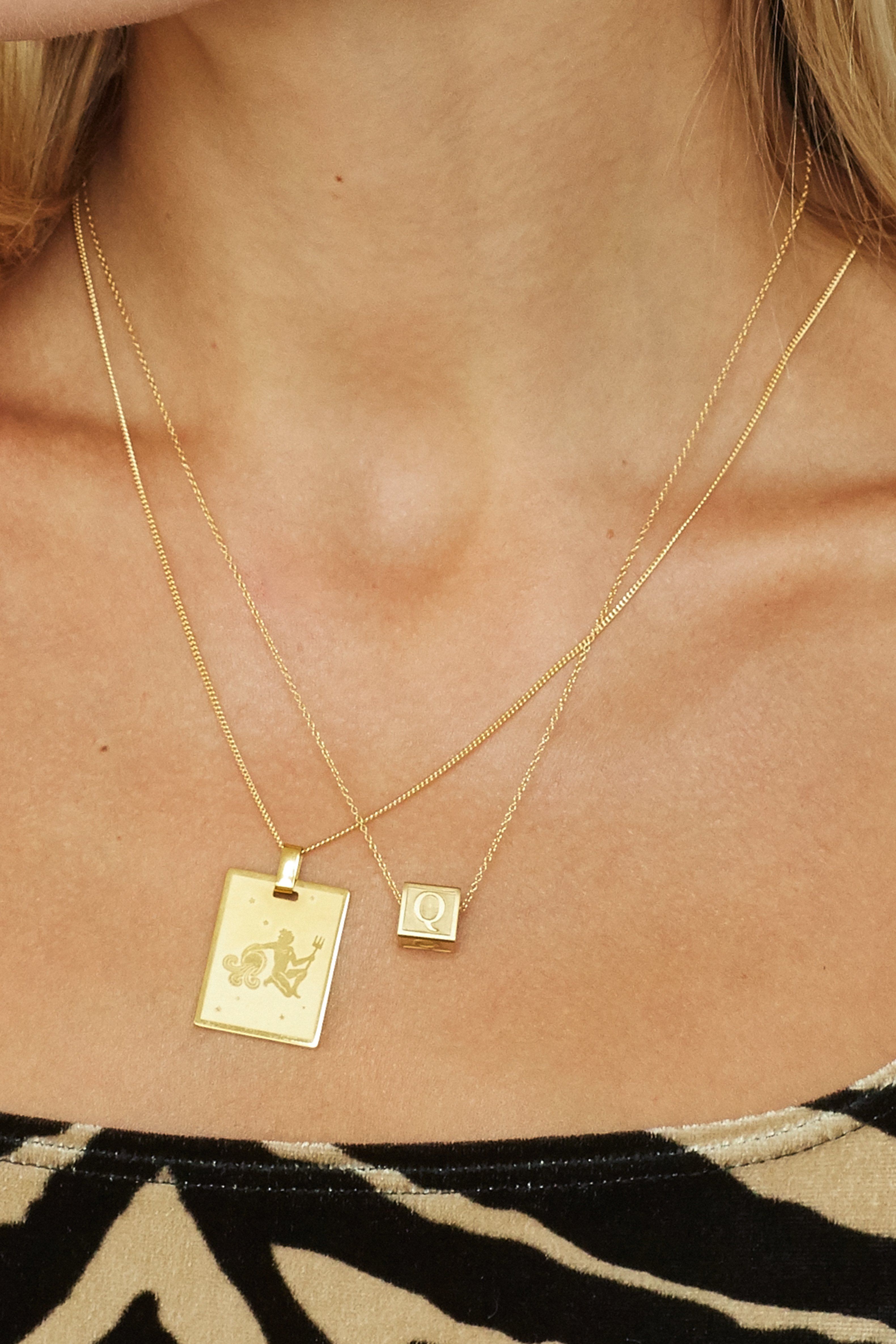 Cropped view on model "Q" Letter Block letters layered with zodiac charm  Bagatiba 