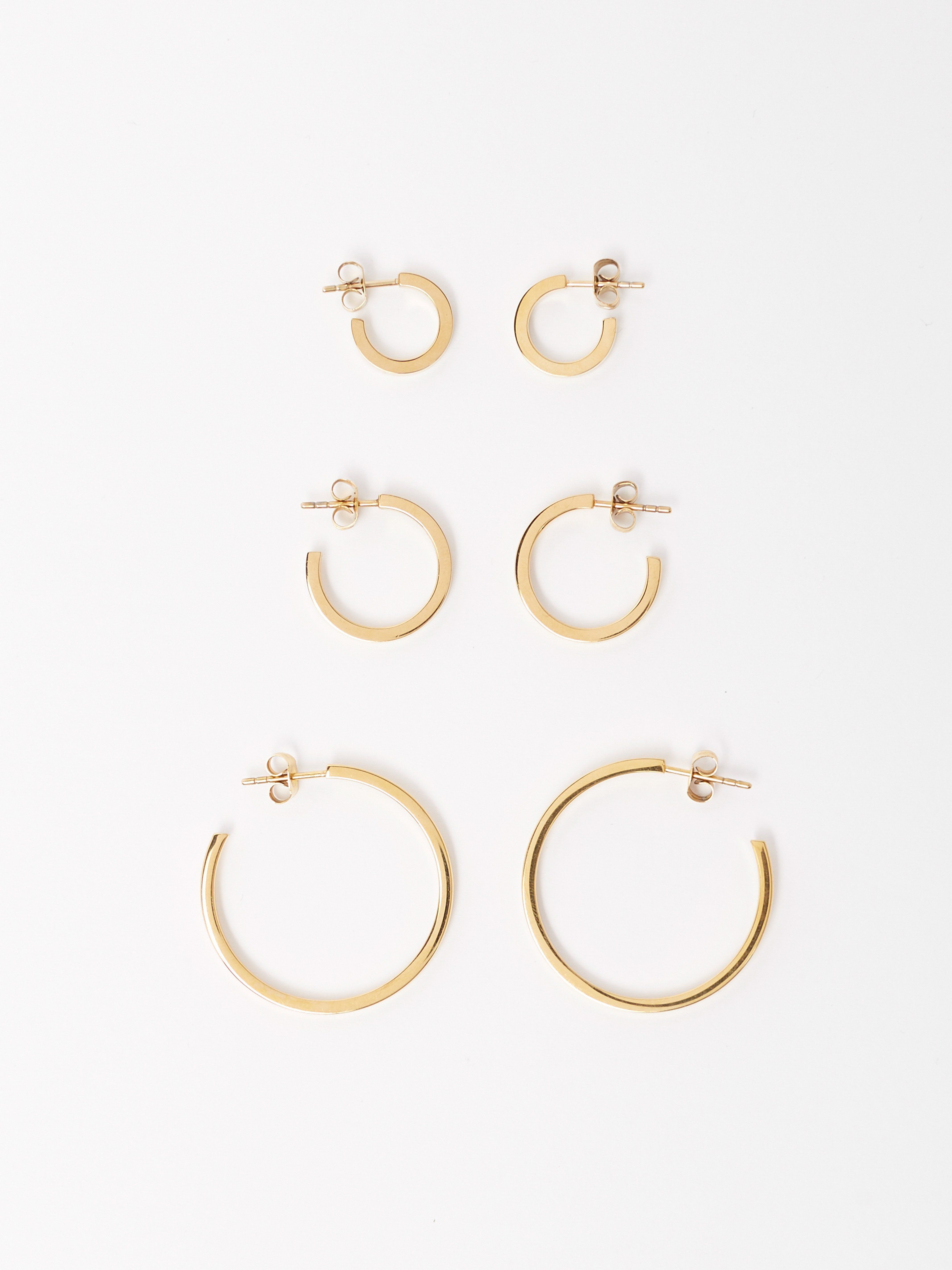 Full view flat lay of the Simple Gold Hoops, Small Simple Gold Hoops and Mini Simple Gold Hoops Earrings by Bagatiba 