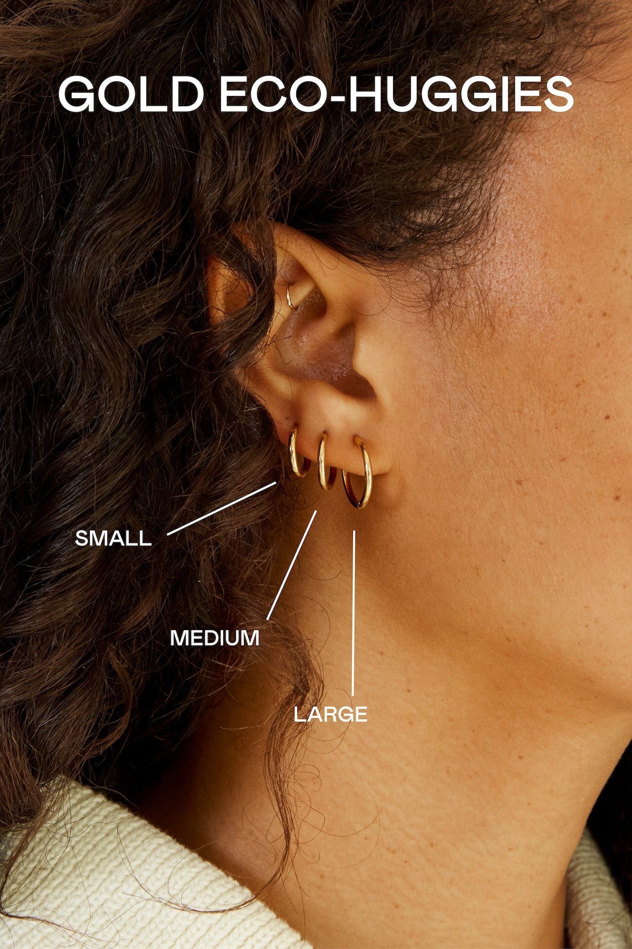 Small, Medium and Large Gold Eco Huggies Earrings by Bagatiba shown to scale on model's ear