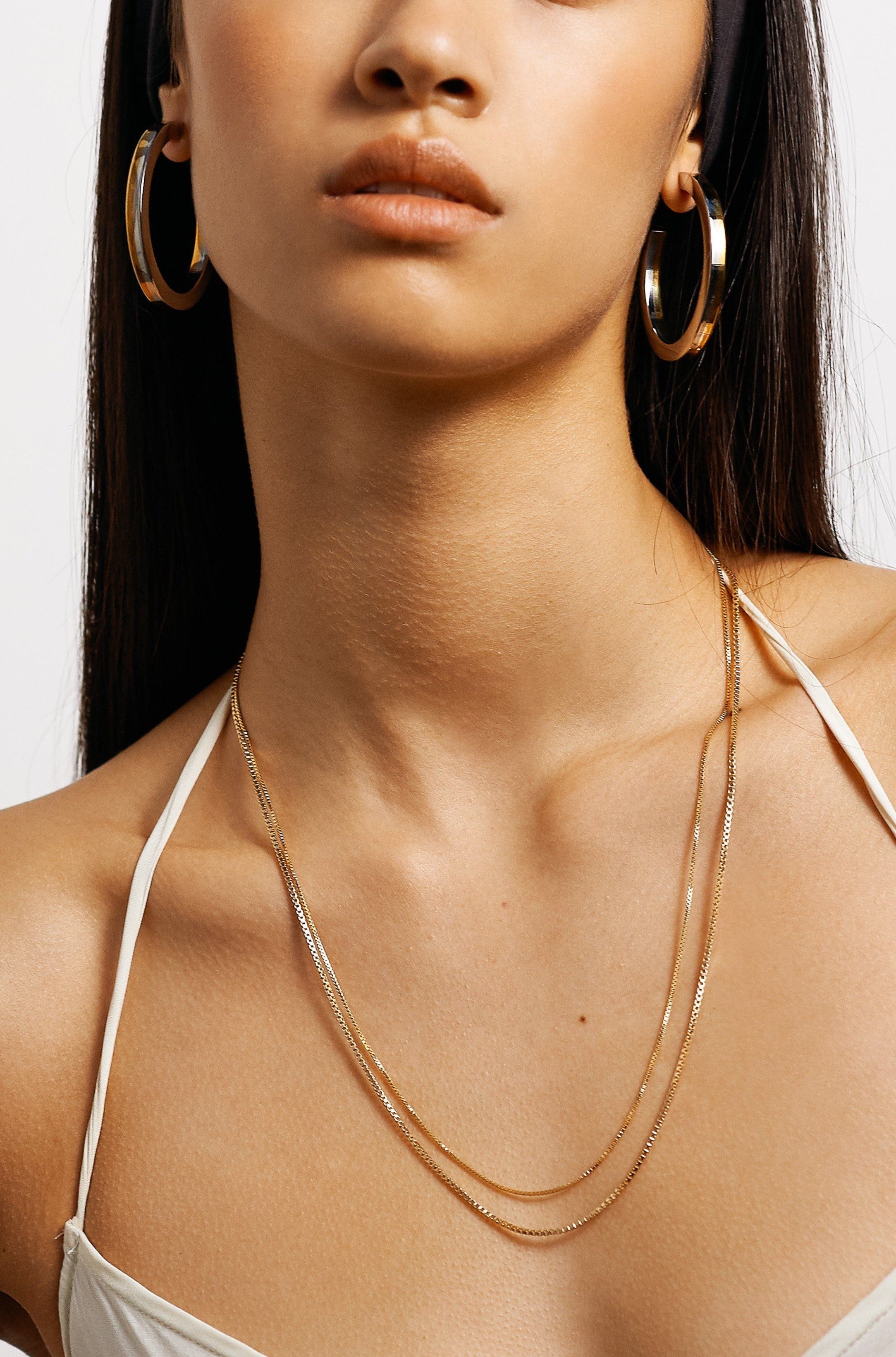 Model wearing the Two Tone Flat Hollow Hoops Earrings Bagatiba 