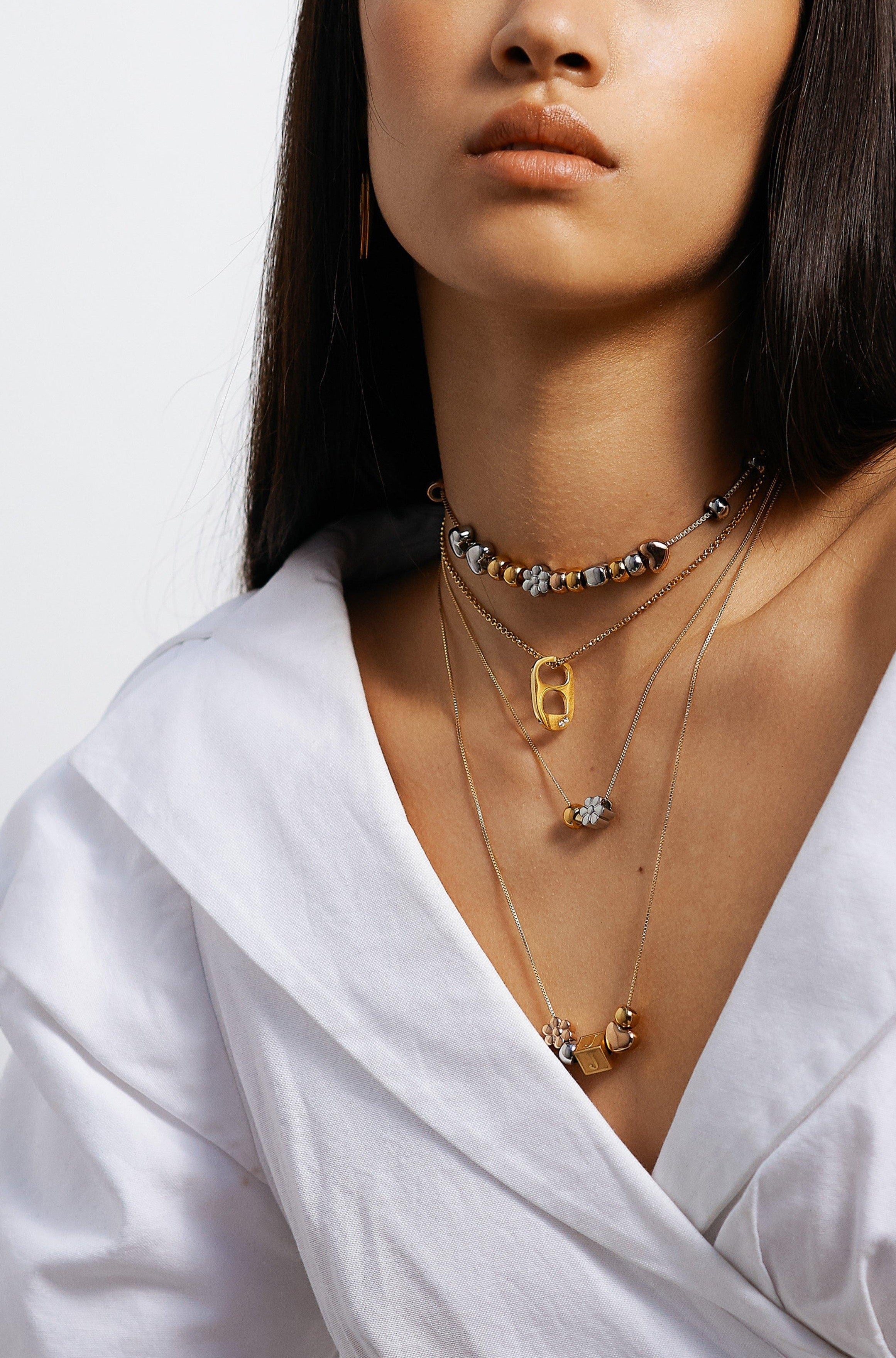Full view of model wearing 4 custom build it necklaces Bagatiba 