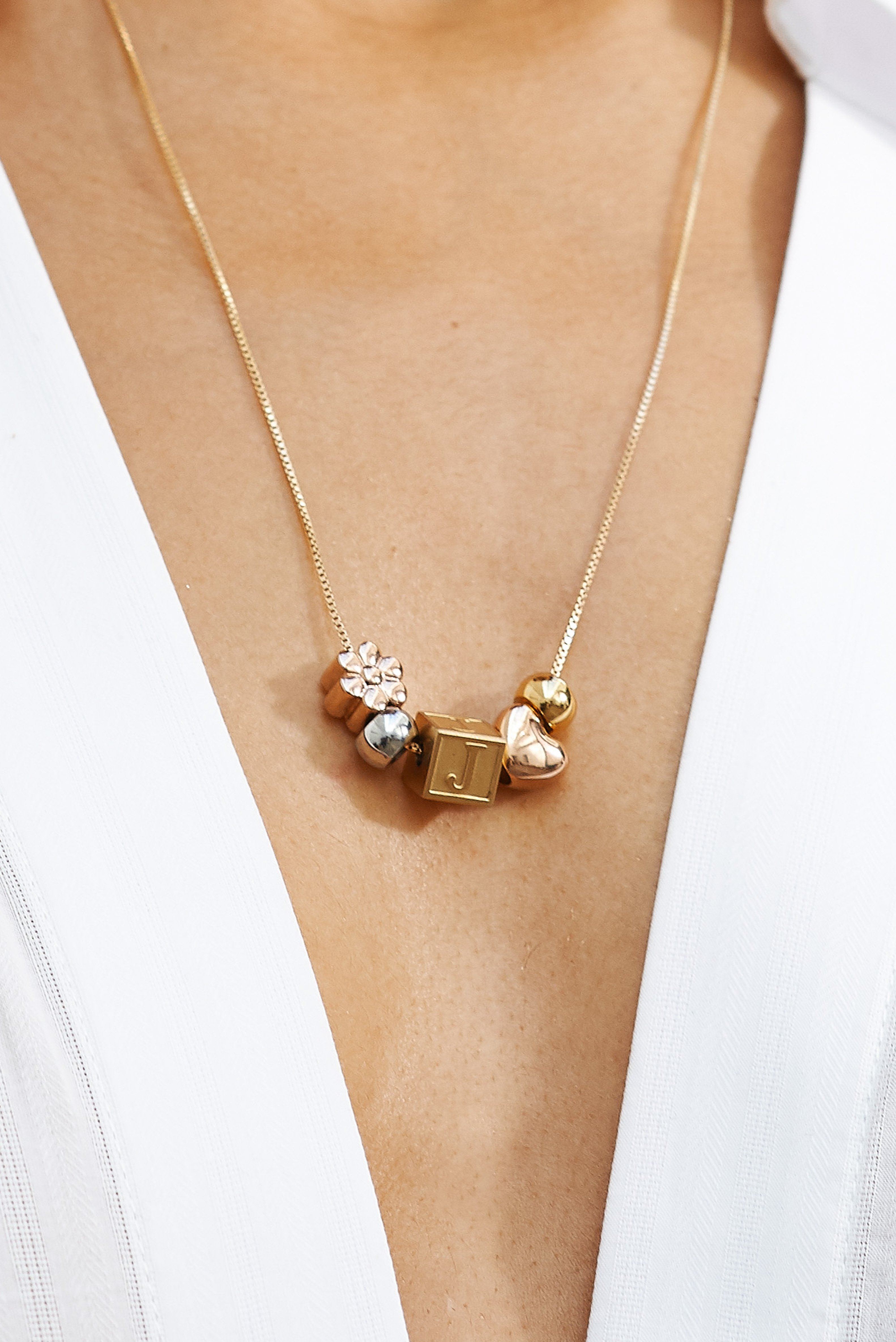 Close up on model "J" Letter Block letters and 4 beads on long chain Bagatiba