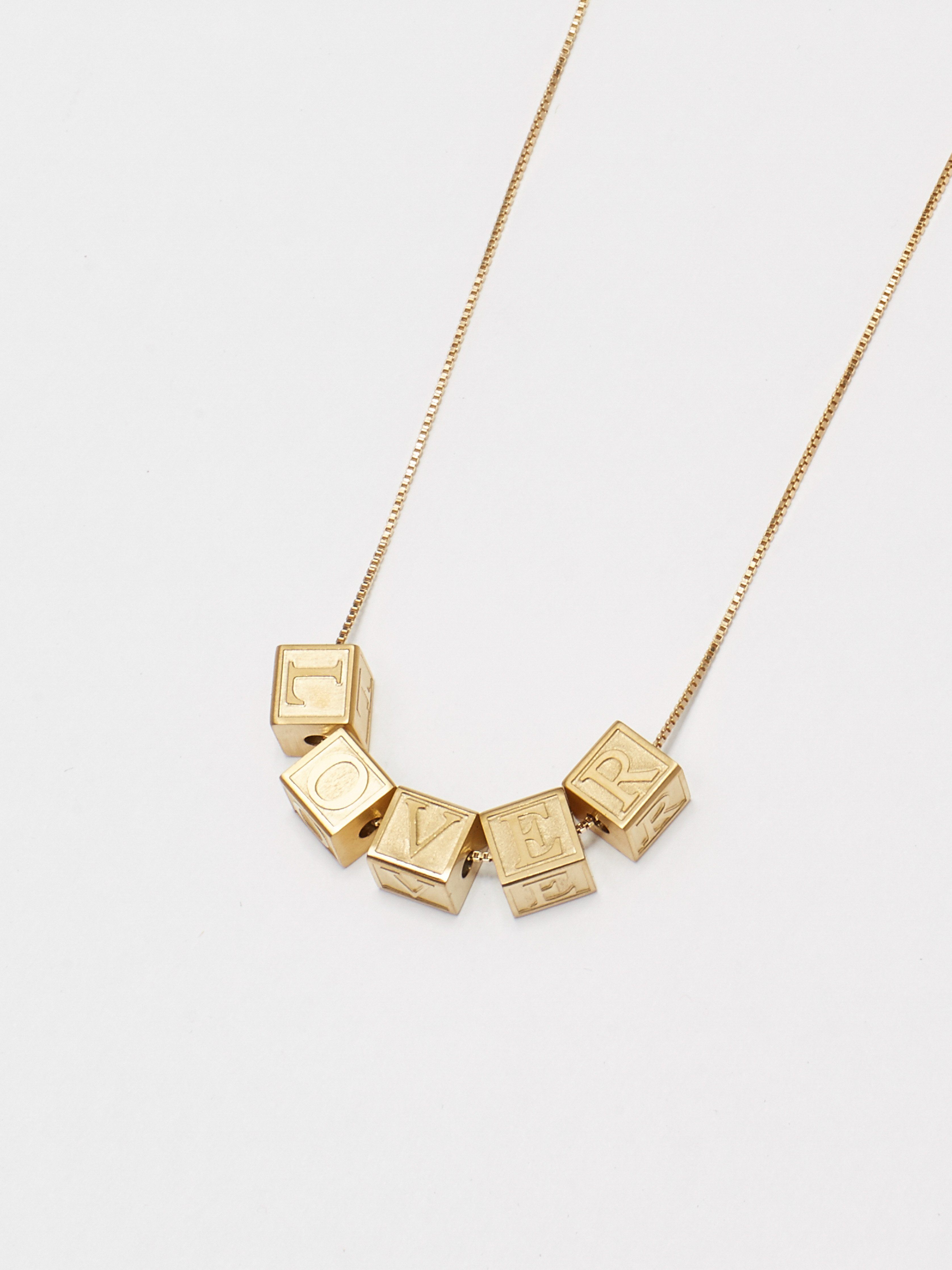 Close up flat lay of letter blocks "L" "O" "V" "E" "R" on 22" square chain Bagatiba